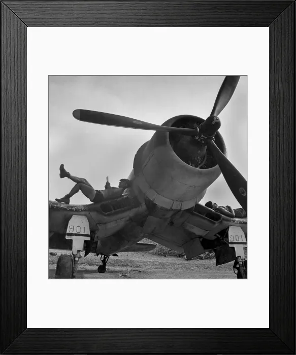 Framed Print : Two Marines on Bougainville relaxing in between strikes against the Japanese. They lounge on the bent wings of a F4U Corsair fighter, April 1944. (BSLOC_2013-12_169)