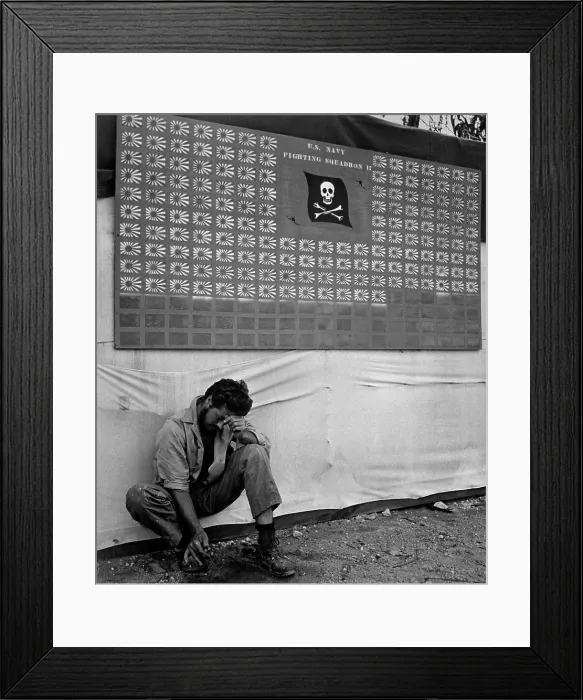 Framed Print : Skull & Crossbones Squadron scoreboard at Bougainville, in the Southwest Pacific, Feb. 1944. Beneath the trophy flags for Japanese killed, sits a member of the squadron