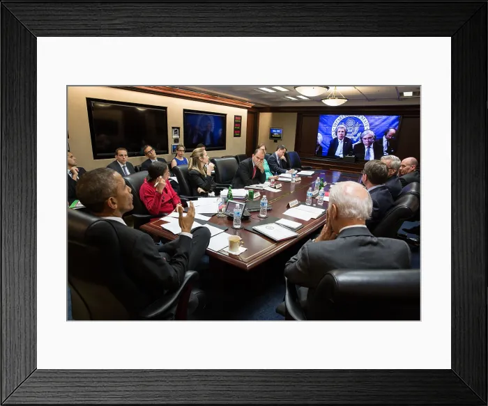 Framed Print : President Obama and National Security team in teleconference on the P5+1 negotiations with Iran. March 31, 2015. On the screen are Sec. of State John Kerry, Sec