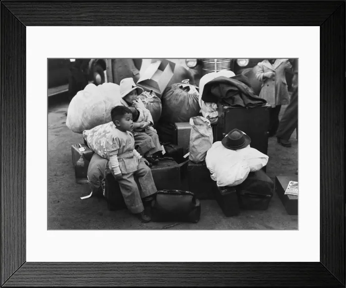 Framed Print : Japanese American children sit among their family's belongings as they wait for transportation to Owens Valley Assembly center for internment during World War II