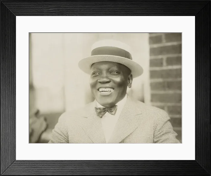 Framed Print : Boxer John Johnson, smiling broadly, in a checkered jacket, bow tie, and straw hat, c. 1909-12. He held the World Heavyweight Championship from Dec Framed Print : Boxer John Johnson, smiling broadly, in a checkered jacket, bow tie, and straw hat, c. 1909-12. He held the World Heavyweight Championship from Dec