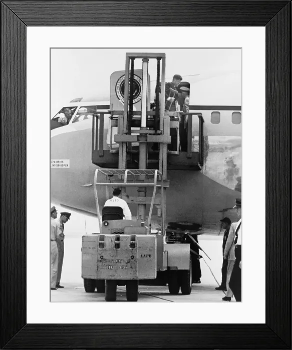 Framed Print : President John F. Kennedy on crutches disembarking from Air Force One by fork lift