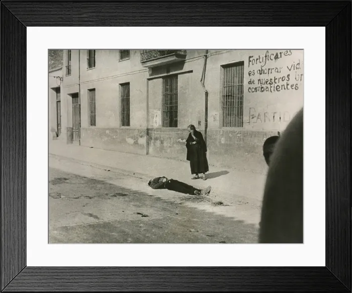 Framed Print : A mother looks on the body of her son in a street of Castillon, Spain. Aug. 8, 1938. It is not known for which side this man fought. Spanish Civil War, July 1936-March 1939