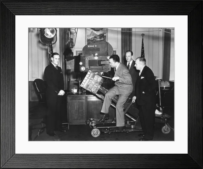 Framed Print : FBI Director J. Edgar Hoover with a Newsreel camera at Universal Studios. Clyde Tolson, Hoover's FBI colleague and personal companion is on far left. Ca. 1935-40