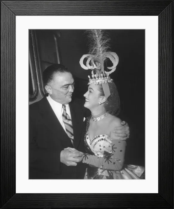 Framed Print : J. Edgar Hoover and actress Dorothy Lamour, looking into each others eyes. She is in costume on the set The Greatest Show on Earth in 1951