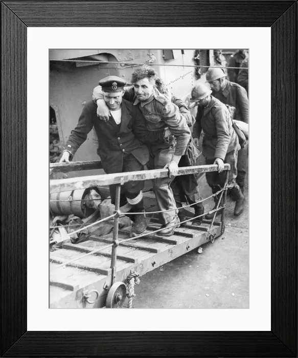 Framed Print : A British sailor assisting a wounded Tommy followed by French Troops. They are arriving safely in England from the beaches of Dunkirk. World War 2. May 26-June 4, 1940