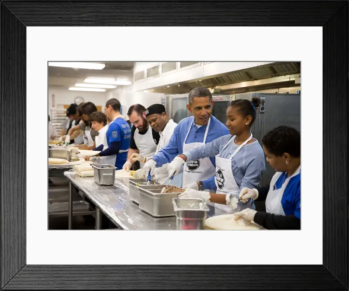 Framed Print : President Barack Obama and his daughter Sasha assemble burritos at DC Central Kitchen. It was a Martin Luther King, Jr. Day of Service event in Washington, D.C. Jan. 20, 2014
