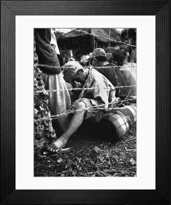 Framed Print : Japanese soldier sits dejectedly in a prisoner of war enclosure on Okinawa. June 1945, during World War 2. (BSLOC_2013_14_277)