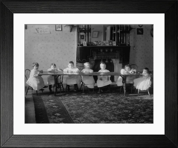 Framed Print : Seven toddlers sit at a table at the Childrens Aid Society