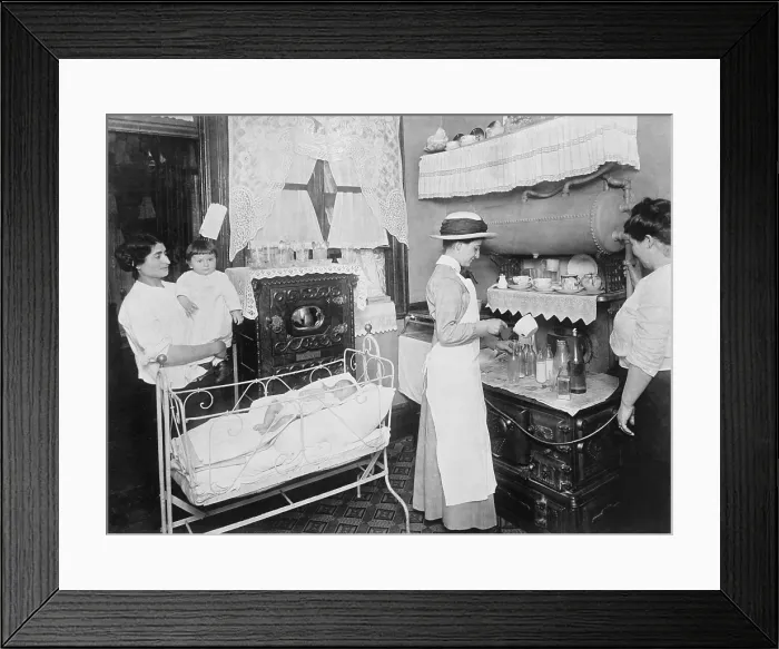 Framed Print : Public health nurse instructs a mother in the preparation of milk formulas for her baby. Nurses made house calls to reach into poor neighborhoods, June 1919 (BSLOC_2018_1_159)
