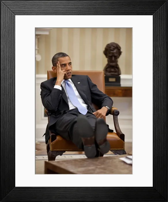 Framed Print : President Barack Obama listens during to advisors in the Oval Office. June 8, 2011. In the background is a portrait bust of Abraham Lincoln. (BSLOC_2015_3_6)