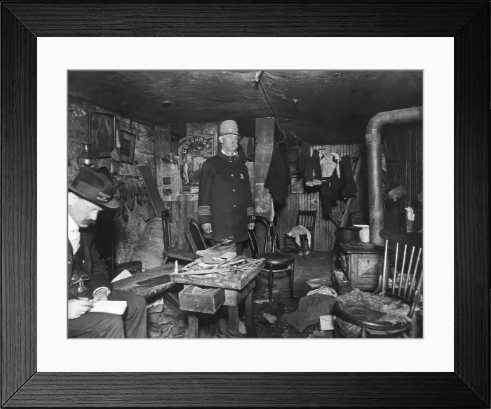 Framed Print : New York City policeman and a housing inspector in a cluttered basement rental c. 1900
