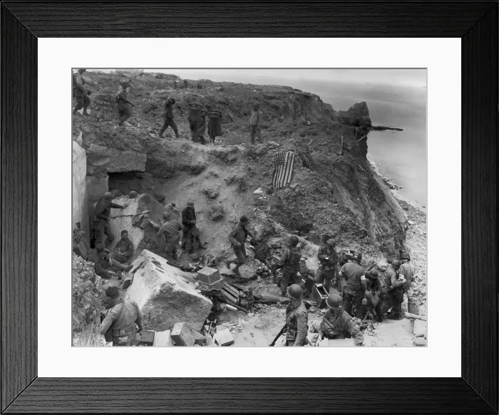 Framed Print : German prisoners captured by U.S. Rangers on Pointe du Hoc, during D-Day Invasion. The American flag signals the position is in U.S. hands to prevent friendly fire from tanks Framed Print : German prisoners captured by U.S. Rangers on Pointe du Hoc, during D-Day Invasion. The American flag signals the position is in U.S. hands to prevent friendly fire from tanks