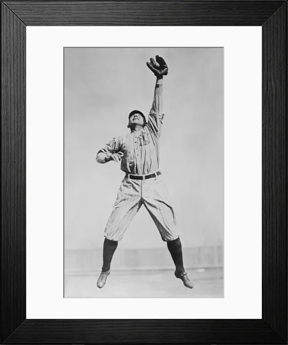 Framed Print : Frank Home Run Baker, in a New York Yankees uniform, reaching to catch a ball. He played in Major League Baseball from 1908 to 1922, and was with the Yankees from 1915-22