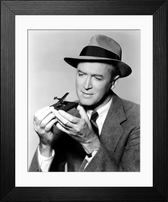 Framed Print : THE SPIRIT OF ST. LOUIS, star James Stewart, admiring a 14-carat gold replica of Charles Lindbergh's titular plane, 1957