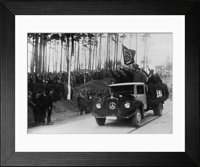 Framed Print : Hermann Goring in group at left receives the Nazi salute from men riding in a decorated Mercedes truck during inaugural ceremonies for the German Autobahn. April 4 1936