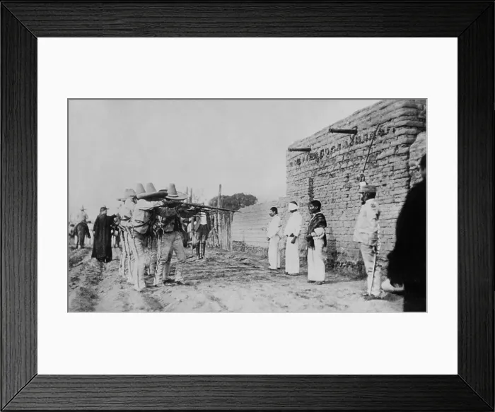 Framed Print : Mexican Rurales executing prisoners of war during the Mexican Revolution, c. 1914. The blindfolded man was shot first and the other two followed