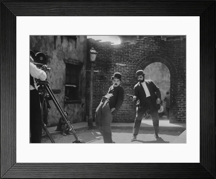 Framed Print : Charlie Chaplin, in the publicity still from the 1921 movie, THE KID. Jackie Coogan co-starred as the Tramps adopted son and sidekick Framed Print : Charlie Chaplin, in the publicity still from the 1921 movie, THE KID. Jackie Coogan co-starred as the Tramps adopted son and sidekick