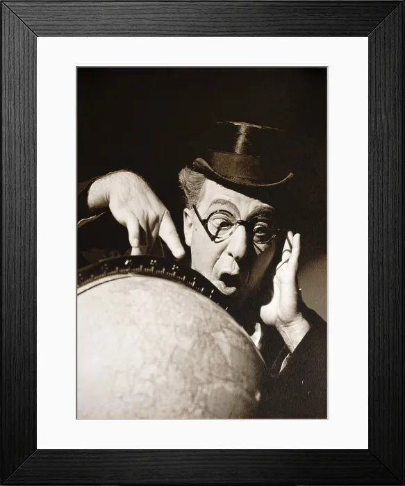 Framed Print : Actor Ed Wynn poses behind a globe of earth with astonished expression. Photo is possibly a publicity still for one of his radio shows of the 1930s (BSLOC_2018_3_22)