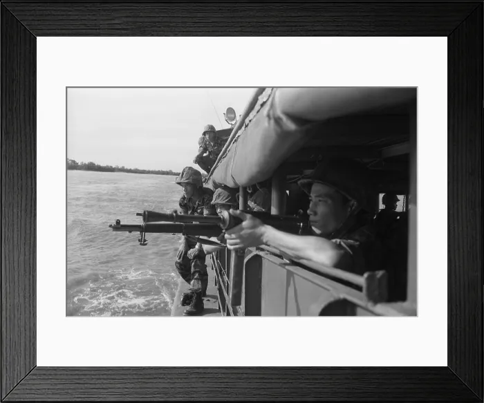 Framed Print : Vietnamese soldiers inspecting the shoreline from inside a boat to prepare for landing. Feb. 15, 1962. Photo by Robert Pepper Martin. (BSLOC_2015_14_134)