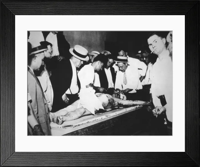 Framed Print : John Dillinger's bloody corpse in the Chicago County morgue. He was shot outside a theater by FBI agents on July 22, 1934 - (BSLOC_2015_1_9) Framed Print : John Dillinger's bloody corpse in the Chicago County morgue. He was shot outside a theater by FBI agents on July 22, 1934 - (BSLOC_2015_1_9)