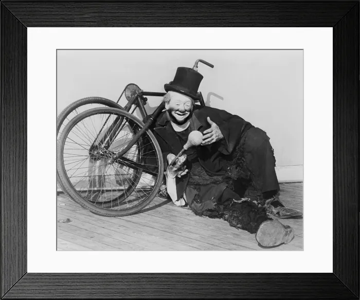Framed Print : Hobo clown Joe Jackson reclining against a disassembled bicycle at the New York World's Fair in 1940