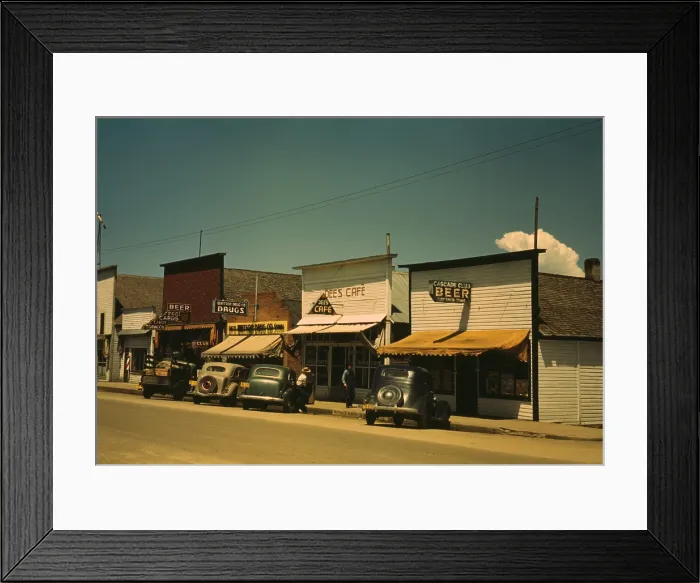 Framed Print : Five businesses on the main street of Cascade Idaho include two bars a cafe drug store and barber shop. 1943 photo by Russell lee. (BSLOC_2010_18_99)