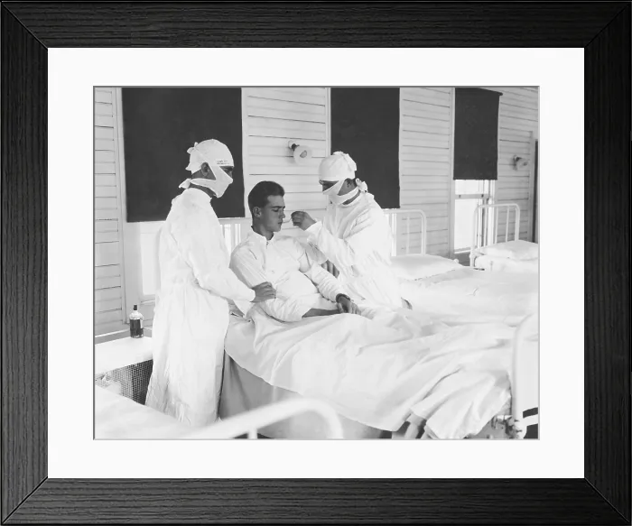 Framed Print : Spanish Flu Epidemic 1918-1919 in America. Masked medical personnel giving treatment to an influenza patient at the U.S. Naval Hospital, New Orleans, Louisiana, c. Oct