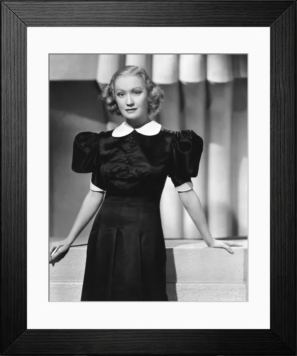 Framed Print : WOMAN CHASES MAN, Miriam Hopkins, in a black satin dress by Omar Kiam, 1937