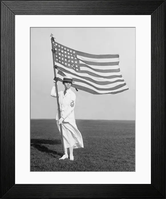 Framed Print : World War 1 era US Navy Yeoman in white summer dress holding American Flag, 1916-1919. Yeomen performed administrative and clerical work Framed Print : World War 1 era US Navy Yeoman in white summer dress holding American Flag, 1916-1919. Yeomen performed administrative and clerical work