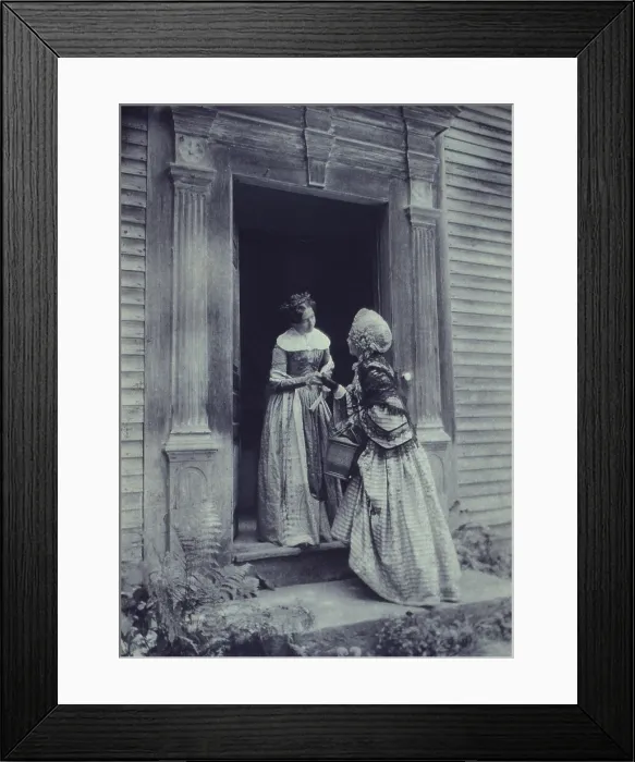 Framed Print : HOW DY DO? Staged photograph of two women, in mid-19th century period costumes, standing in a doorway conversing