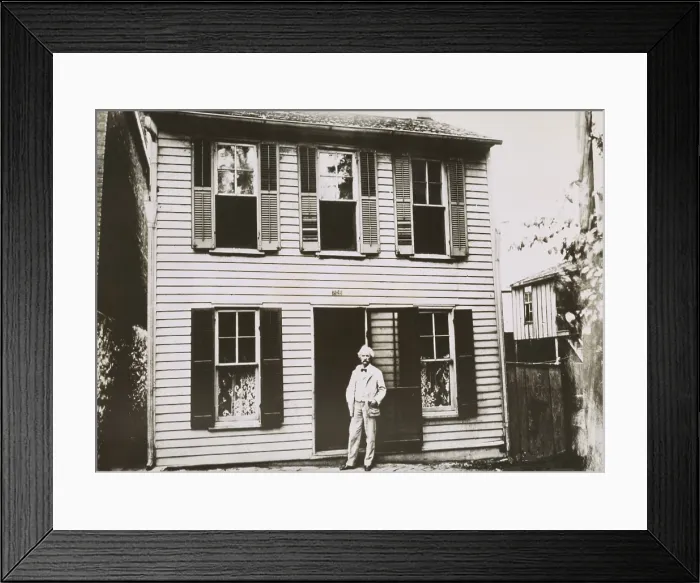 Framed Print : Mark Twain (aka Samuel Clemens), in front of his boyhood home in Hannibal, Missouri, c. 1900. The great American writer was born Samuel Langhorne Clemens in 1835 Framed Print : Mark Twain (aka Samuel Clemens), in front of his boyhood home in Hannibal, Missouri, c. 1900. The great American writer was born Samuel Langhorne Clemens in 1835