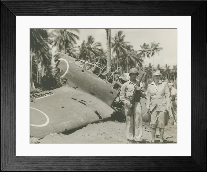 Framed Print : First Lady Eleanor Roosevelt visiting Guadalcanal, Sept 13-16, 1943. She stands with sentry, Pvt. Clarence D. Robertson, of Tulsa, Oklahoma, near wrecked Zeroes