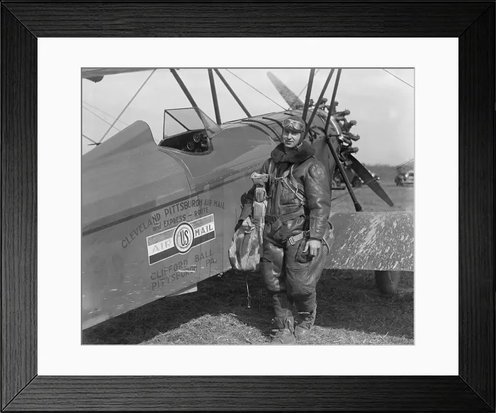Framed Print : Aviator standing with plane labeled Cleveland Pittsburgh Air Mail and Express Route, c. 1920-26 Framed Print : Aviator standing with plane labeled Cleveland Pittsburgh Air Mail and Express Route, c. 1920-26