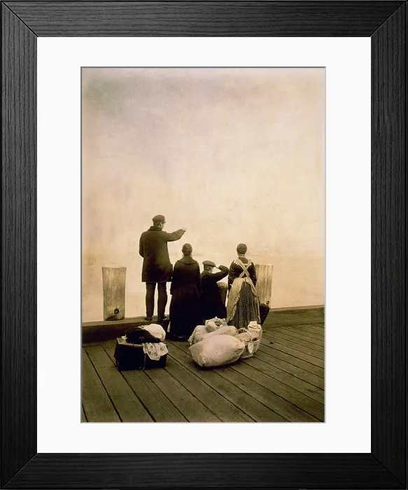 Framed Print : Immigrant family and their belongings on a dock, looking out over the water. Ca. 1912