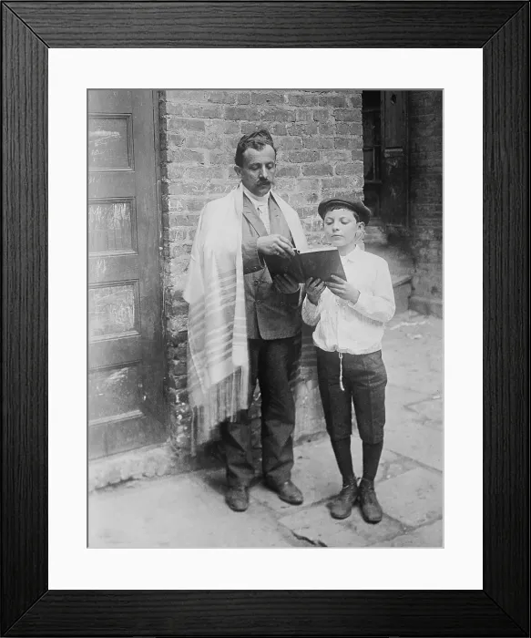Framed Print : Jewish man wearing a prayer shawl and boy reading from Hebrew Bible on Yom Kippur, in New York City. Ca.1910