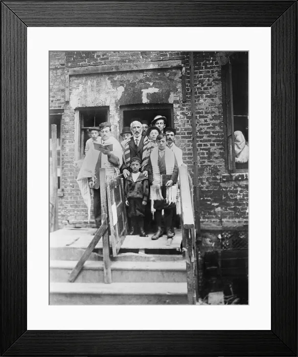 Framed Print : Jewish men and boys in prayer shawls standing in front of a dilapidated tenement synagogue on Yom Kippur. New York City. Ca.1910