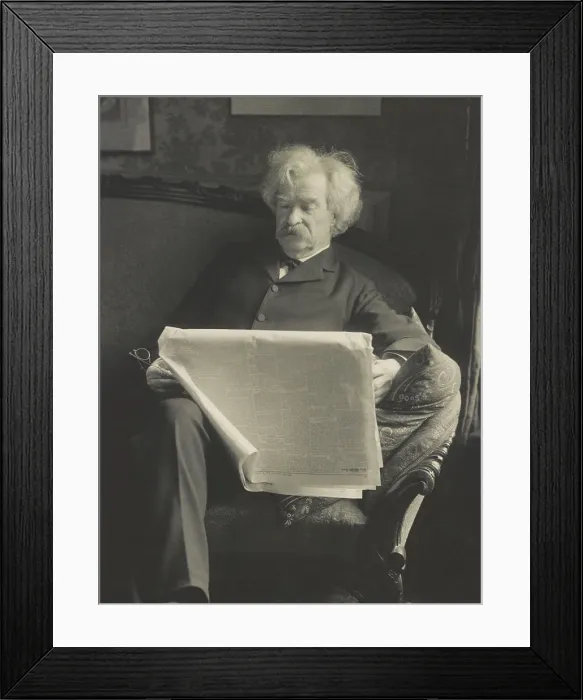 Framed Print : Mark Twain (aka Samuel Clemens), American writer and satirist, in photo by Charles E. Bolles. He is reading a newspaper dated, May 7, 1901 (BSLOC_2016_11_131)