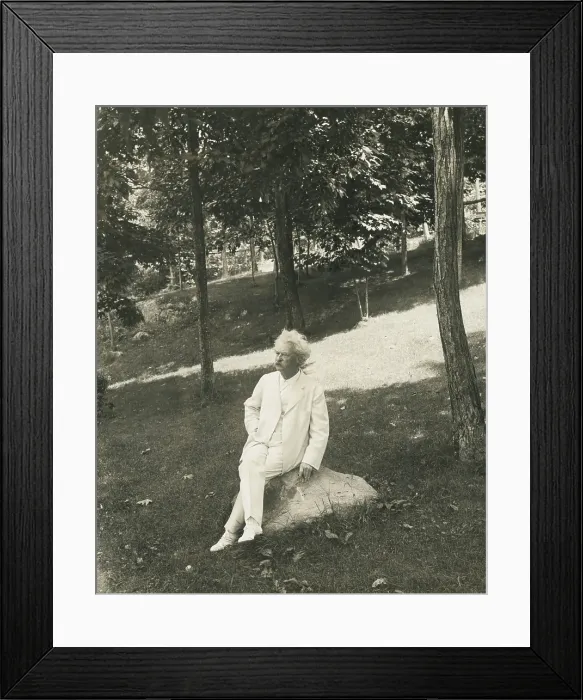 Framed Print : Mark Twain (aka Samuel Clemens), seated on a rock in a park. 1905-1910 (BSLOC_2016_11_136)