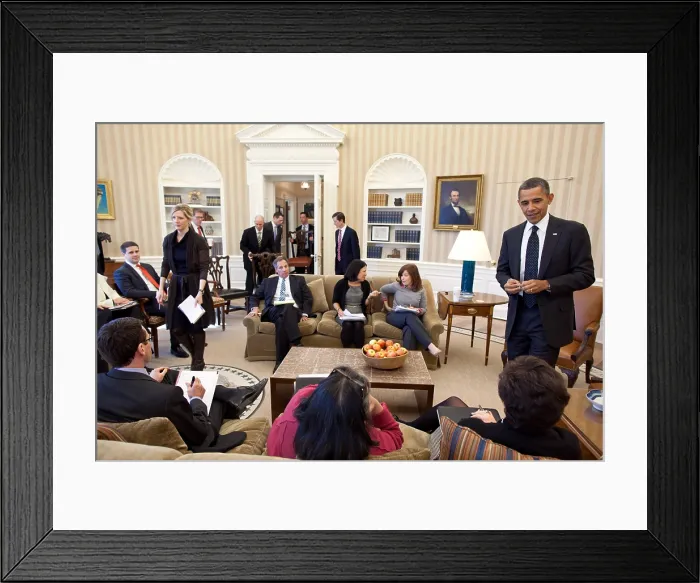 Framed Print : President Obama's staff carry in their chairs before an Oval Office meeting. Feb. 7, 2012. At left the President talks with Senior Advisor Valerie Jarrett. (BSLOC_2015_13_263)