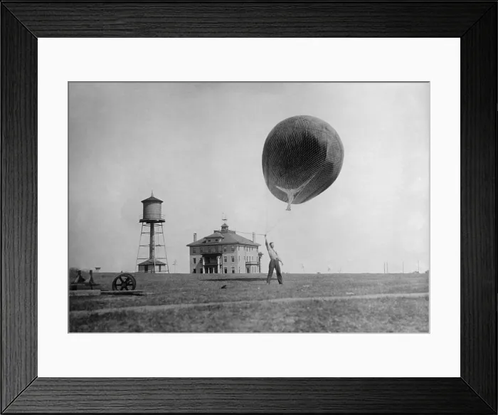 Framed Print : Man about to release a Weather Bureau balloon, c. 1910-1920. It will fly free and be tracked from ground to measure wind speeds, c. 1910-1920 (BSLOC_2016_10_27)