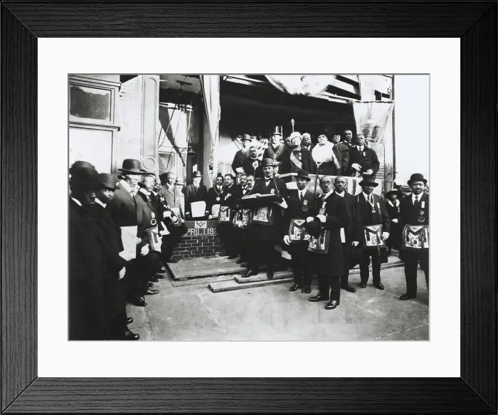 Framed Print : Arthur Alfonso Schomburg in a group of Masons and Odd Fellows, April 1, 1922. He is standing in front of brick wall, right of the inscription Framed Print : Arthur Alfonso Schomburg in a group of Masons and Odd Fellows, April 1, 1922. He is standing in front of brick wall, right of the inscription