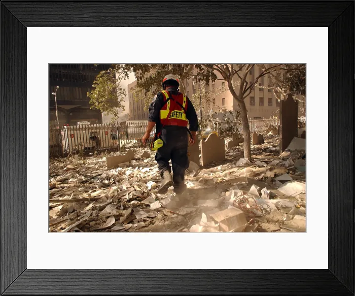 Framed Print : NYC firefighter walks among the old headstones at Trinity Church Cemetery in lower Manhattan. Sept. 19, 2001