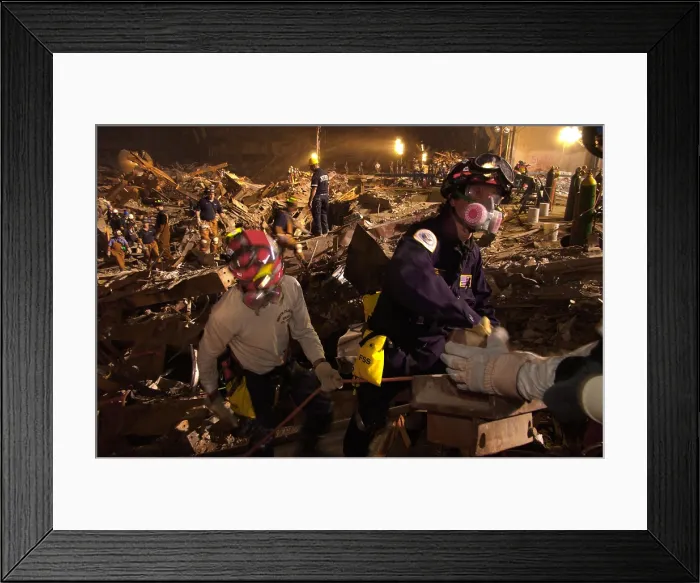 Framed Print : Workers lift rubble and search for survivors. Rescue operations continued into the night at the Ground Zero 7 days after the 9-11 attack on NYC, Sept. 19, 2001