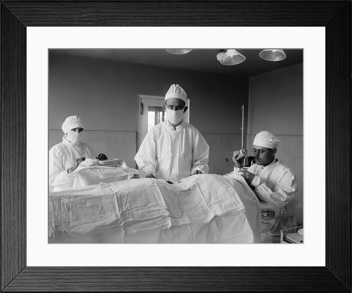 Framed Print : Surgical team before the operation begins, with patient is covered with sterile white cotton fabric. The anesthesiologist at right monitors patient's consciousness