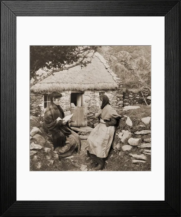 Framed Print : A LETTER FROM PAT IN AMERICA. Young Irish woman reading a letter from a relative in America to an older woman outside of a thatch-roofed stone cottage Framed Print : A LETTER FROM PAT IN AMERICA. Young Irish woman reading a letter from a relative in America to an older woman outside of a thatch-roofed stone cottage