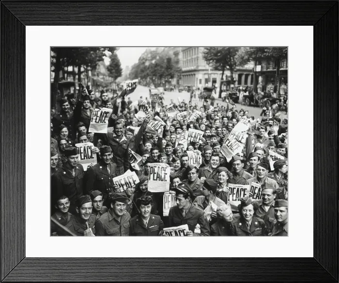 Framed Print : V-J Day in Paris, France. GI's and WACs wave the STARS AND STRIPES headline, PEACE. August 14, 1945. (BSLOC_2015_13_87)