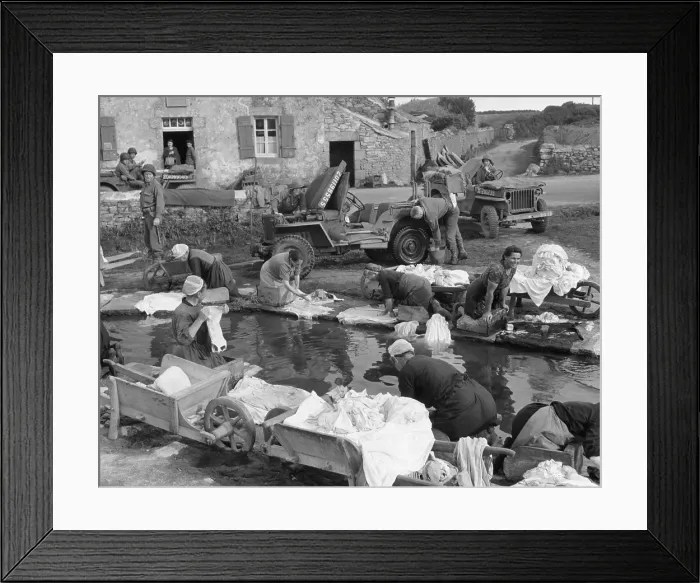 Framed Print : French village women doing their share their laundry facility with GI's washing their Jeep. Sept. 20, 1944, World War 2 (BSLOC_2015_13_84)