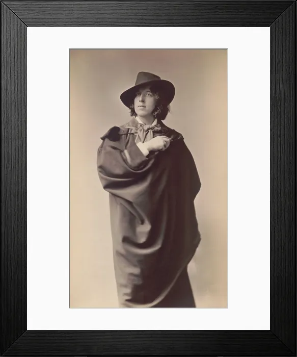 Framed Print : Oscar Wilde, Anglo-Irish playwright and poet in studio portrait by Napoleon Sarony, 1882. Wilde stands with a cape draped dramatically over his body (BSLOC_2016_11_185)