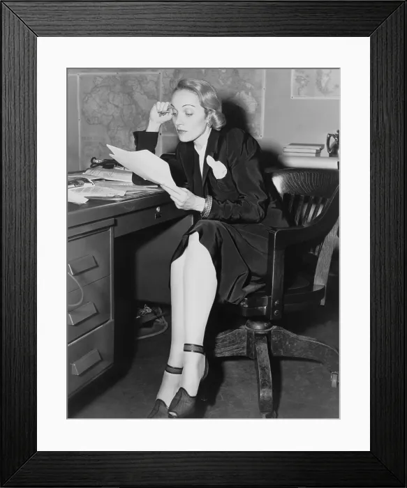 Framed Print : Marlene Dietrich in her office at the U.S. War Department, Bureau of Public Relations, May 1942. As a staunch anti-Nazi, she became an American citizen in 1939